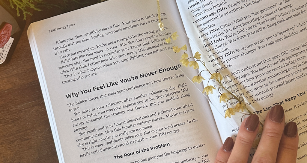 Hand holding open 7 ING energy Types book by Stephanie Mason showing personality types chapter